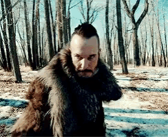 a man in a fur coat is standing in the snow
