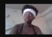 a woman is wearing a white headband and making a funny face