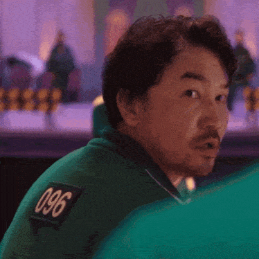 a man in a green shirt with the number 096 on the back