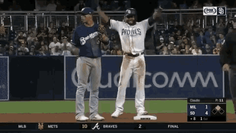 two baseball players on a field with one wearing a jersey that says braves