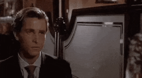 a man in a suit and tie is making a funny face .