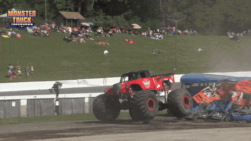 a monster truck is driving down a race track with the words monster truck throwdown in the background