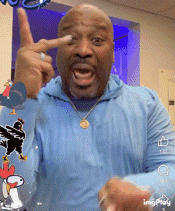 a man wearing a blue shirt with a snoopy sticker on it