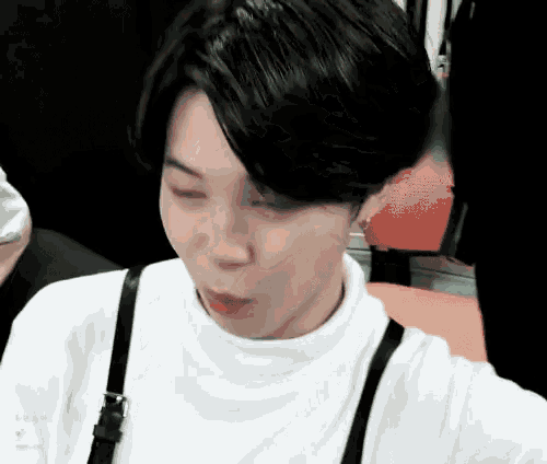 a close up of a person wearing a white turtleneck