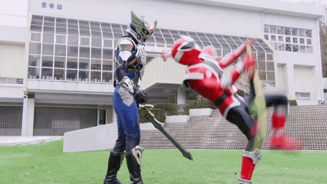 two superheros are fighting in front of a building that says eee