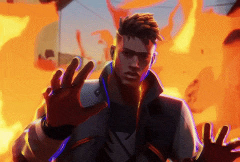 a man is standing in front of a burning building with his hands outstretched
