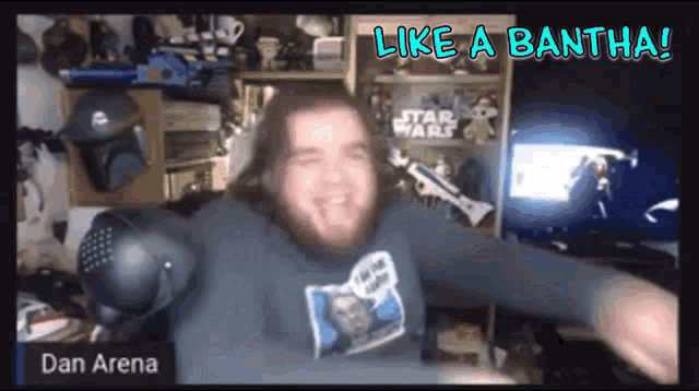 a man wearing a star wars shirt is dancing in front of a screen that says like a bantha