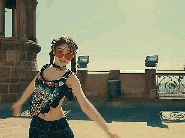 a woman wearing a metallica shirt is dancing