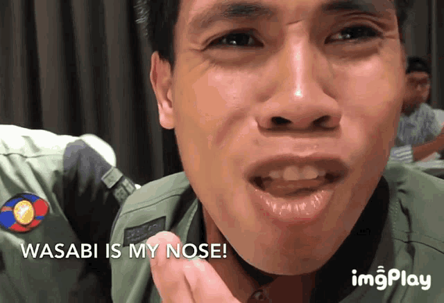 a close up of a man 's face with the words wasabi is my nose above him