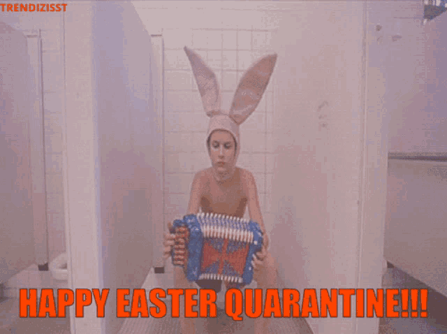 a woman in bunny ears is playing an accordion in a bathroom stall