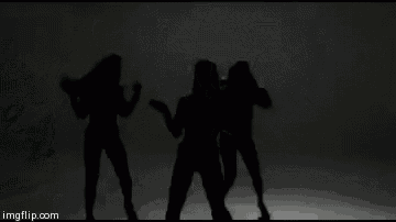 a black and white photo of two women dancing in a room .
