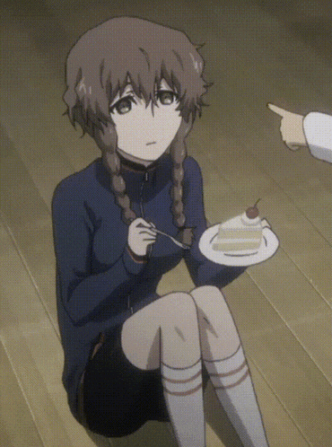 a girl is sitting on the floor holding a plate of food