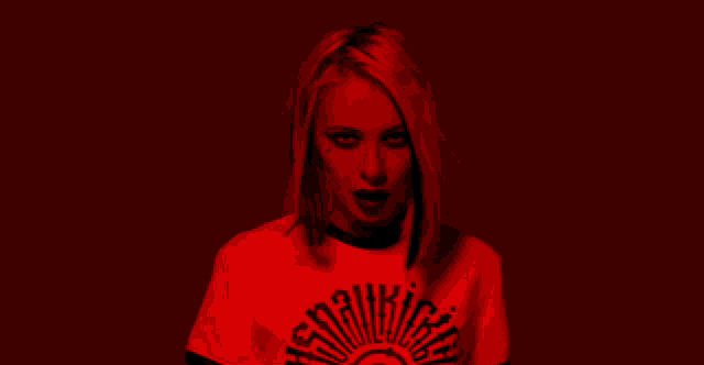 a woman wearing a red shirt that says " sensitive "