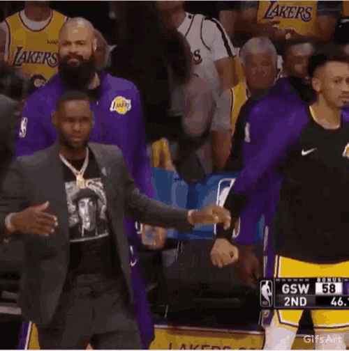 lebron james is wearing a t-shirt with a picture of a man on it during a basketball game