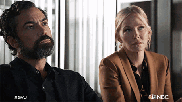 a man with a beard and a woman with blonde hair are sitting next to each other with nbc written on the bottom