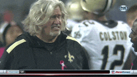 a man in a colston jersey talks to another man on the field