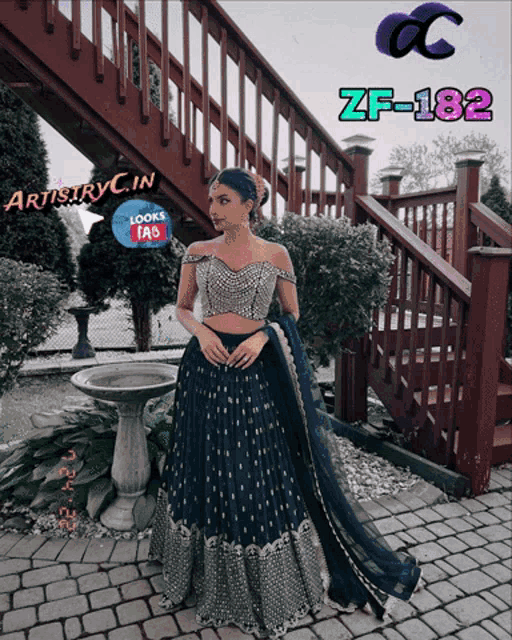 a woman in a green dress is standing in front of a staircase with artistryc.in written on the bottom
