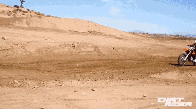 a dirt rider rides a motorcycle on a dirt track