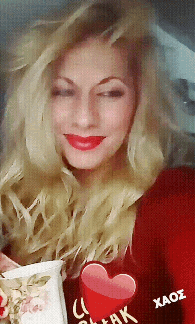 a woman is wearing a red shirt with a heart on it that says " i love you "