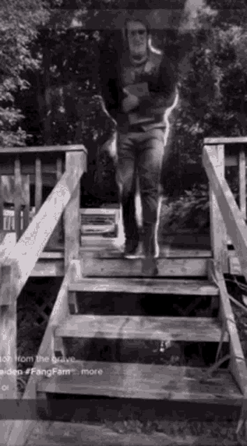 a man is walking up a set of stairs .