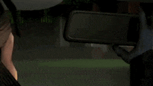 a woman is sitting in the back seat of a car looking at herself in the rear view mirror .