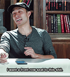 a man sitting at a table with the words i want a front row seat to this shit written below him