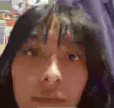 a close up of a woman 's face with a blurry background