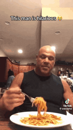 a man is eating a plate of spaghetti with a fork and the caption this man is hilarious