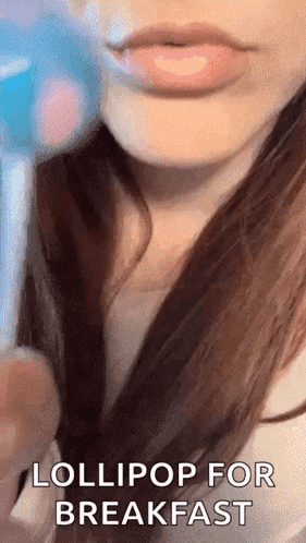 a close up of a woman 's lips with the words lollipop for breakfast .