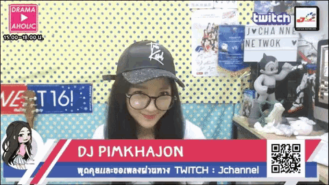 a woman wearing glasses and a hat is on a screen that says twitch