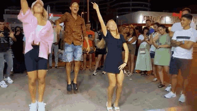 a group of people are dancing in front of a crowd with a sign that says ' mcdonalds ' on it