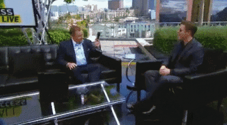 two men are sitting in front of a sign that says sss live
