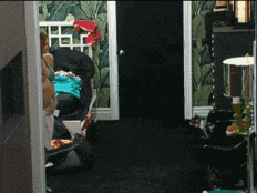 a woman laying on a couch in a room with a black door