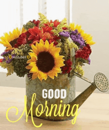 a bouquet of flowers in a watering can with the words good morning written on it