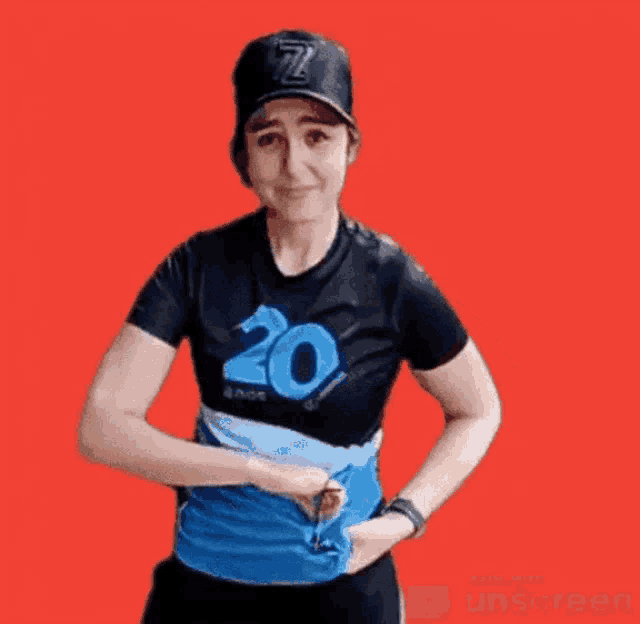 a woman is wearing a black shirt with the number 20 on it
