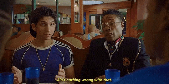two men are sitting at a table in a restaurant and one of them is saying ain t nothing wrong with that .
