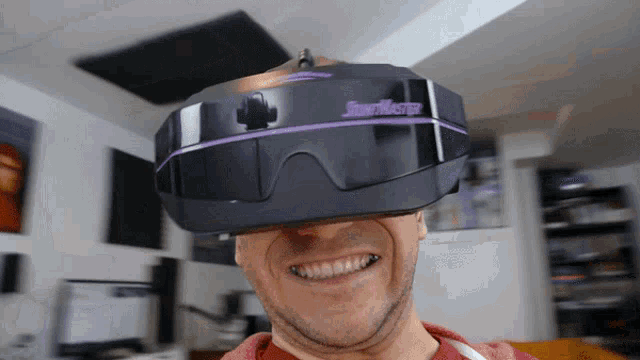 a man is wearing a virtual reality headset that says skymouse