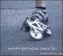 a person is riding a small bicycle on a street .