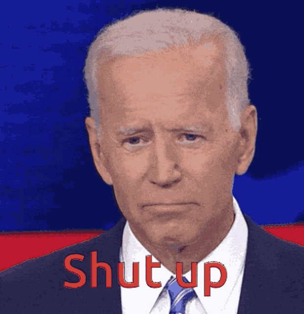 a man in a suit and tie has the word shut up written on his face