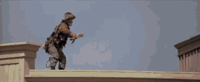 a man wearing a cowboy hat is riding a horse