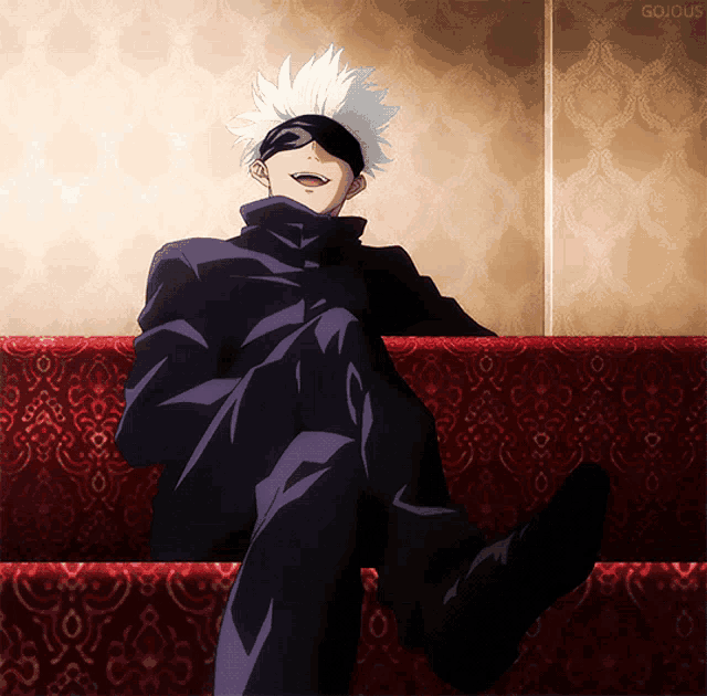 a man is sitting on a red couch with his legs crossed and the word gojous written on the bottom