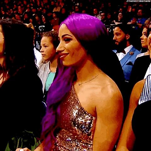 a woman with purple hair is wearing a gold dress