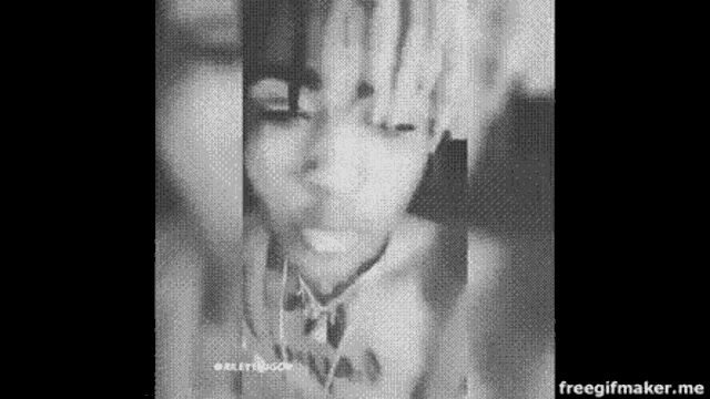 a black and white photo of a person covering their face .