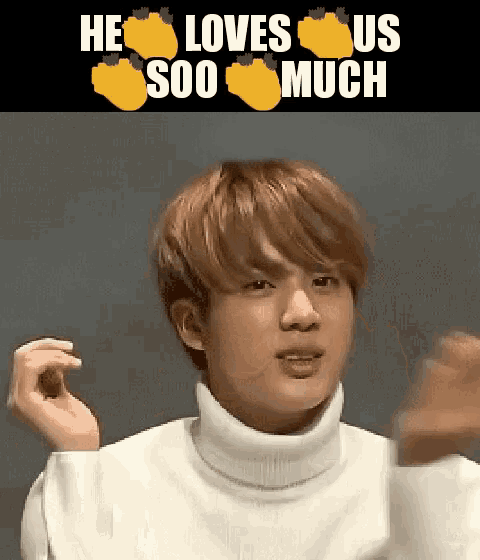 a young man wearing a white turtleneck sweater is making a funny face with his hands in the air .
