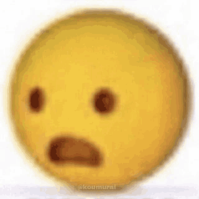 a close up of a yellow smiley face with a surprised expression on it .