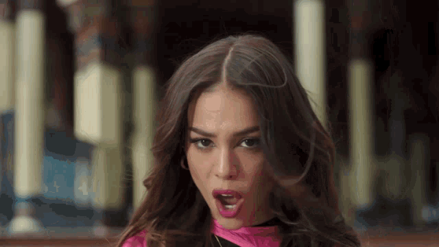 a close up of a woman making a funny face with her mouth open