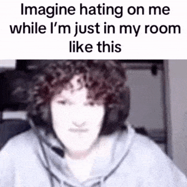 a blurred image of a person wearing headphones with the caption imagine hating on me