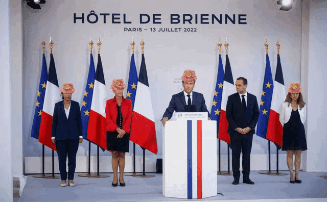 a group of people standing in front of a hotel de brienne sign