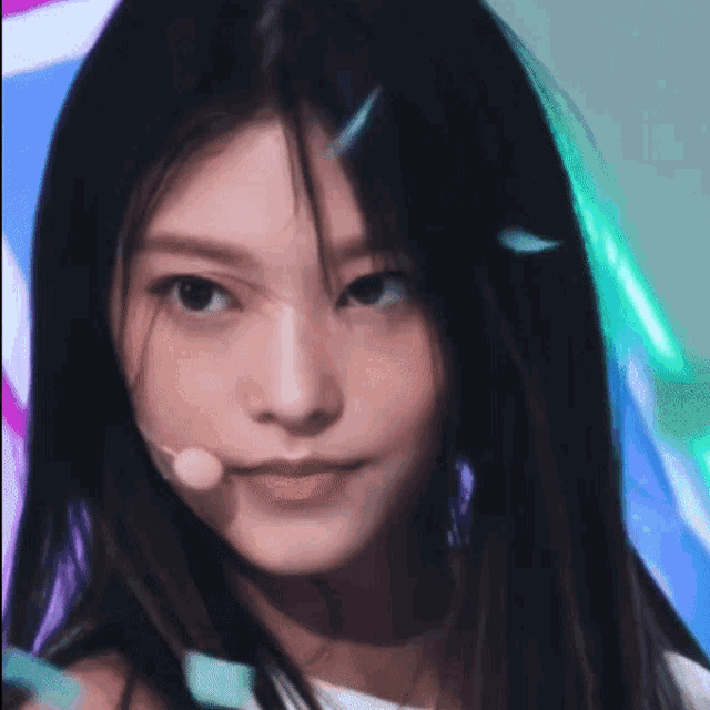 a close up of a woman 's face with a microphone