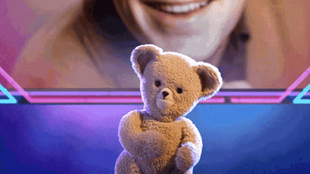 a teddy bear is standing in front of a woman
